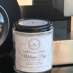 Melanin Drip Savage Candle, scent is cocoa butter cashmere , handmade candle, handcrafted, black owned candle company, in glass jar, soy blend wax. on wood counter