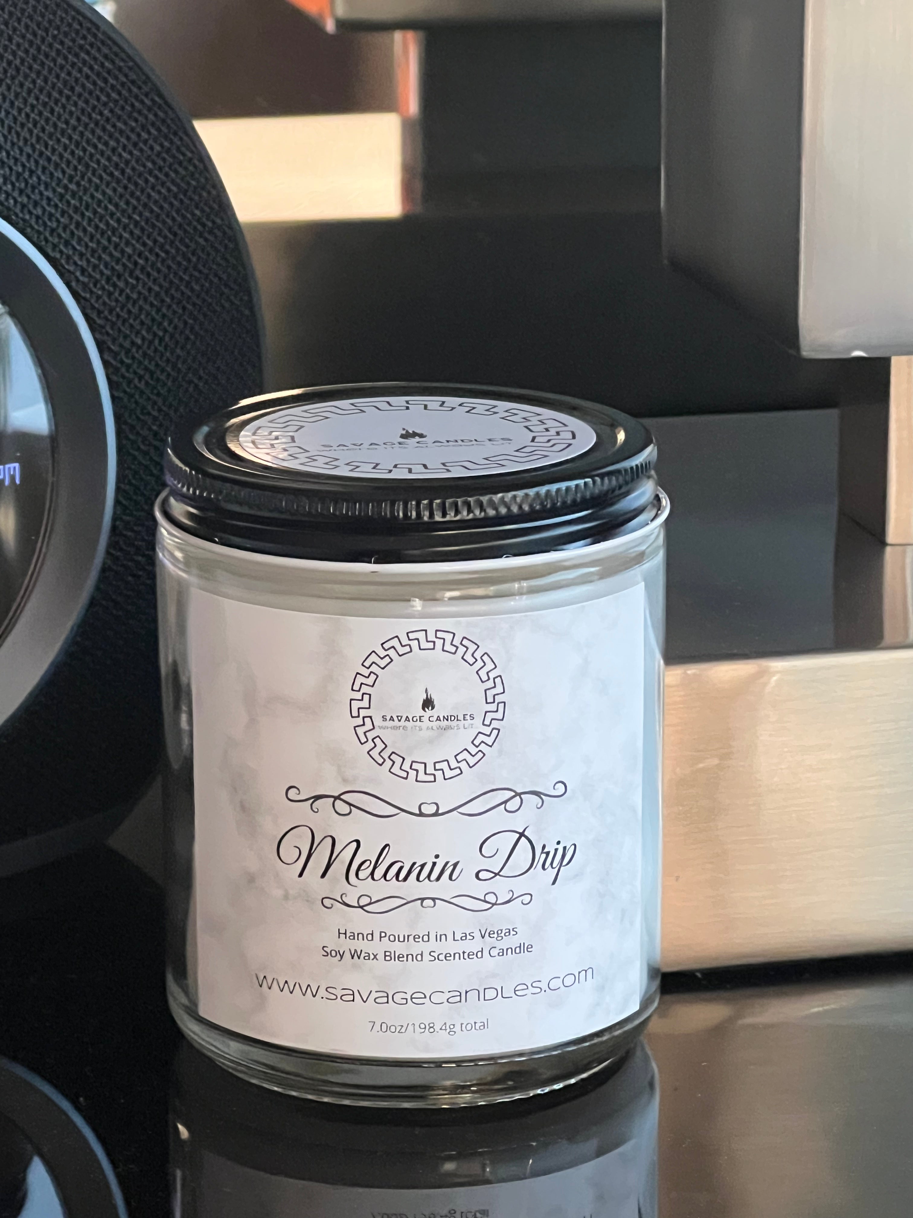 Melanin Drip Savage Candle, scent is cocoa butter cashmere , handmade candle, handcrafted, black owned candle company, in glass jar, soy blend wax. on wood counter